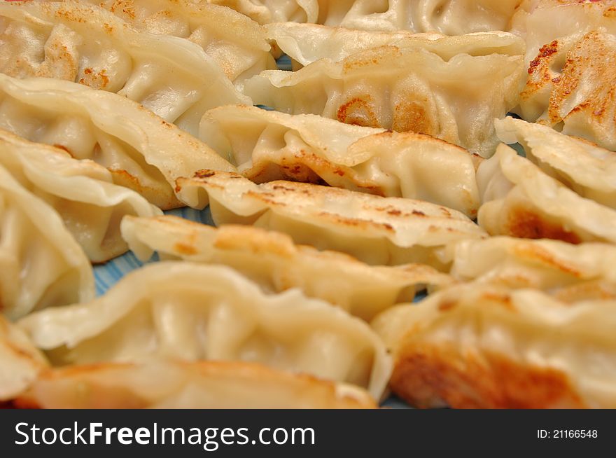 Fried Chinese dumplings on plate background