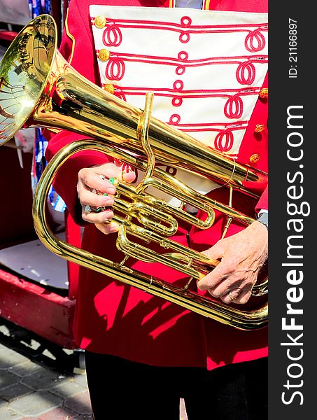 Marching band member holding his baritone horn. Marching band member holding his baritone horn.