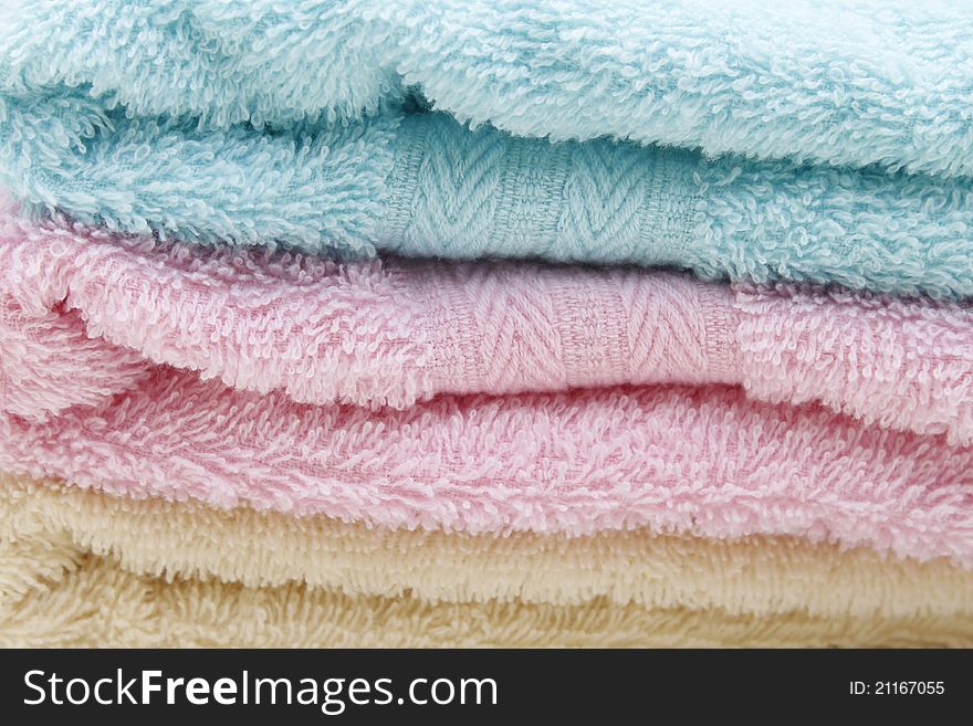 Different shades of towels stacked on each other