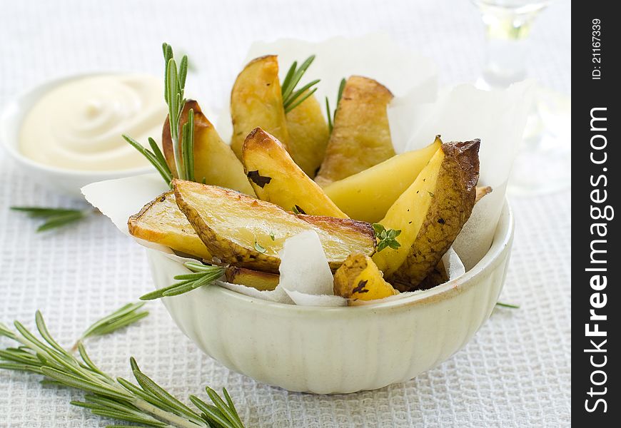 Roasted potatoes with herbs in bowl. Selective focus