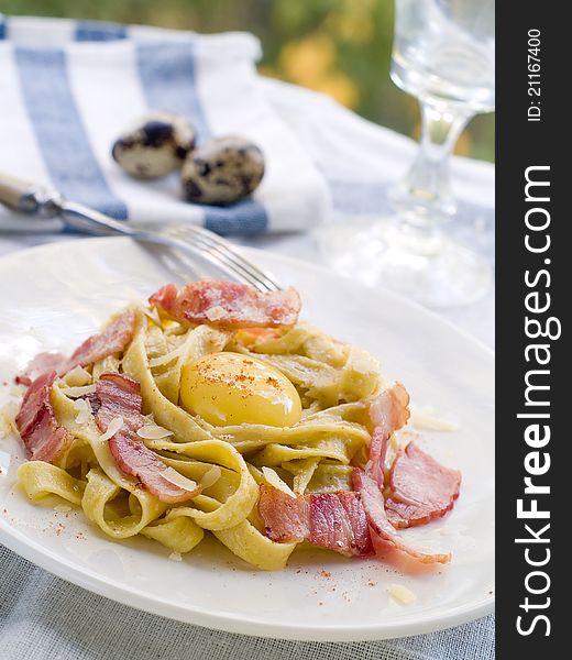 Tagliatelle pasta with bacon and yolk. Selective focus