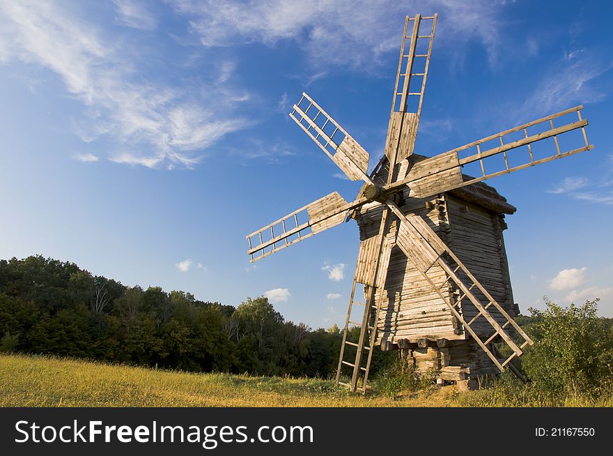 Old wooden windmill at sunset. Old wooden windmill at sunset