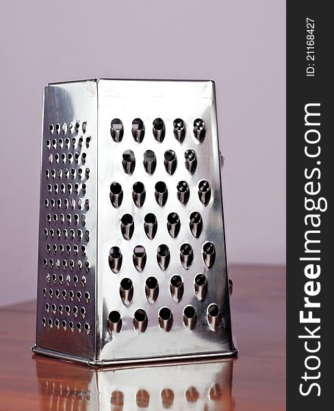 Cheese grater metal and carrots on a table