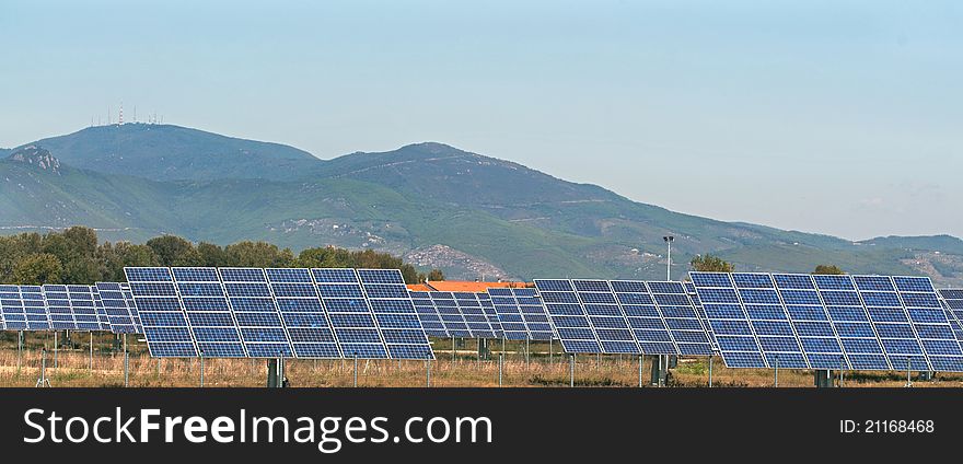 Photovoltaic panels in the country and field of sunflowers