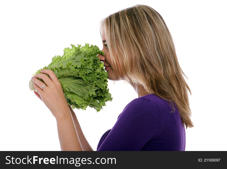 Young woman smelling lettuce close up