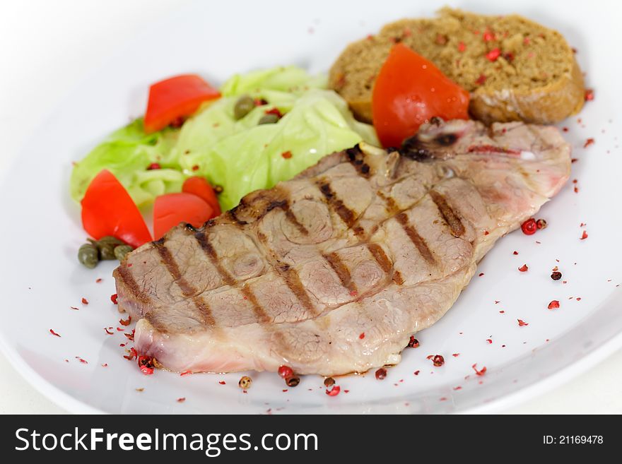 Pork chop, grilled ,with salad,bun and tomato