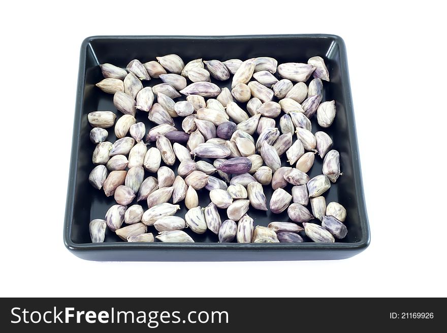 Peanuts on black plate with isolate white blackground.
