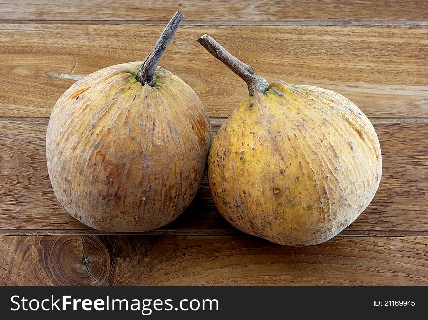 Double santol with teak wood background.