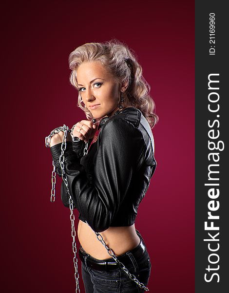 Pretty and danger blond woman in leather jacket with chain. Pretty and danger blond woman in leather jacket with chain