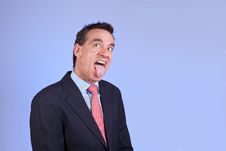 Handsome Business Man Sticking Out Tongue Royalty Free Stock Image