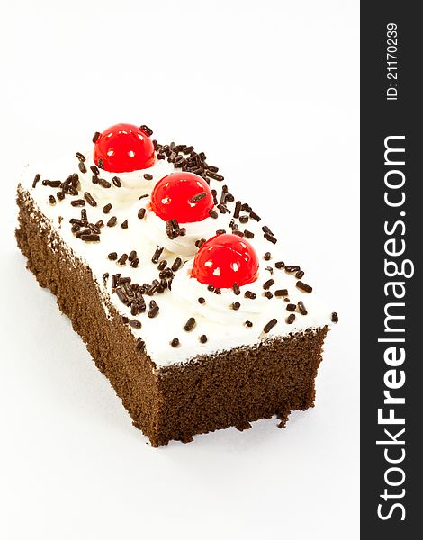 Chocolate cake garnished with cherries and chocolate chips