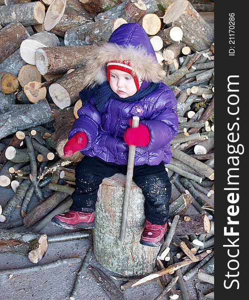 Baby with firewoods in winter