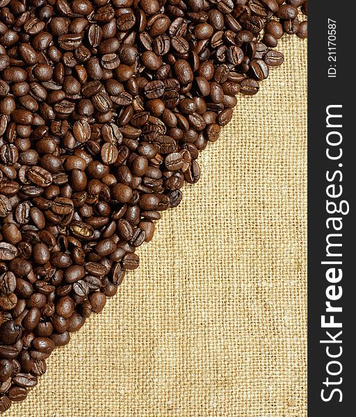 Coffee beans on a burlap texture background