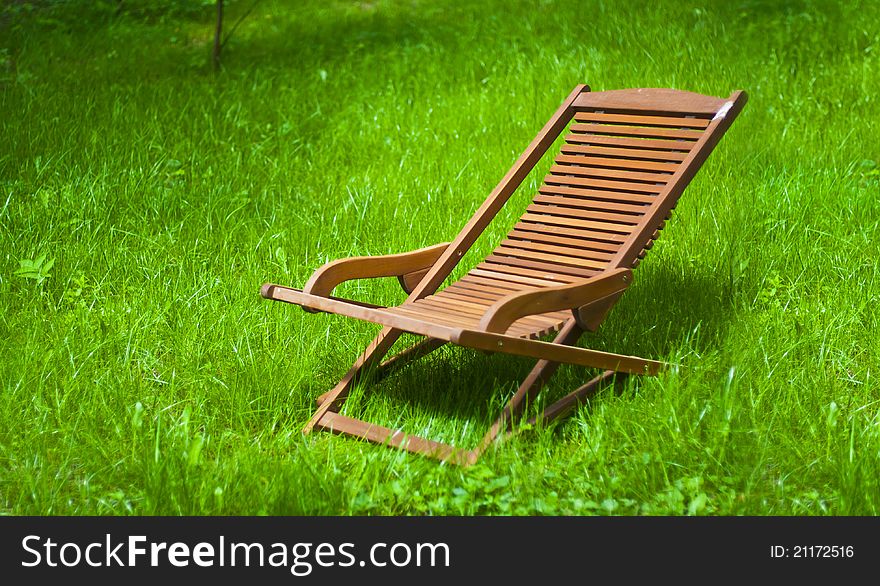 Chaise longue on the grass in bright day. Chaise longue on the grass in bright day
