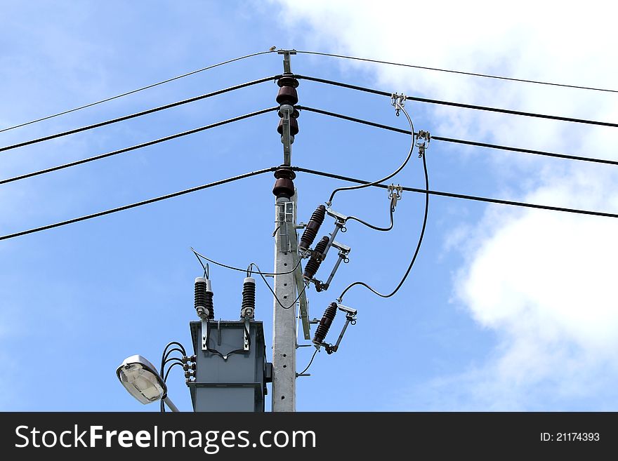 Electric cement pole with cable on blue sky background