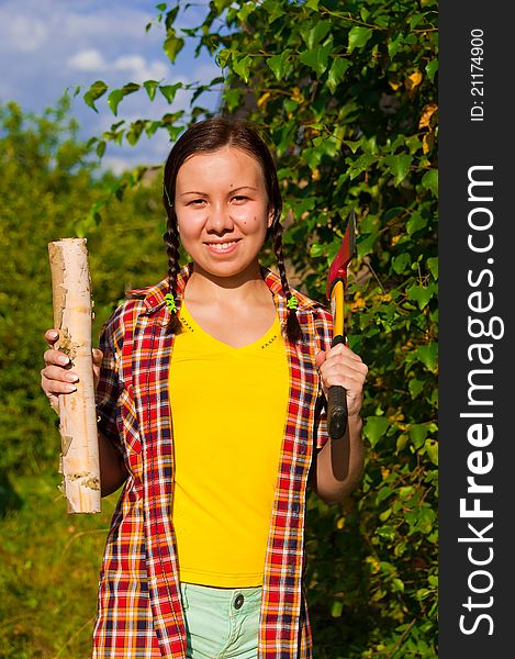Young Woman Holding An Axe And Chock