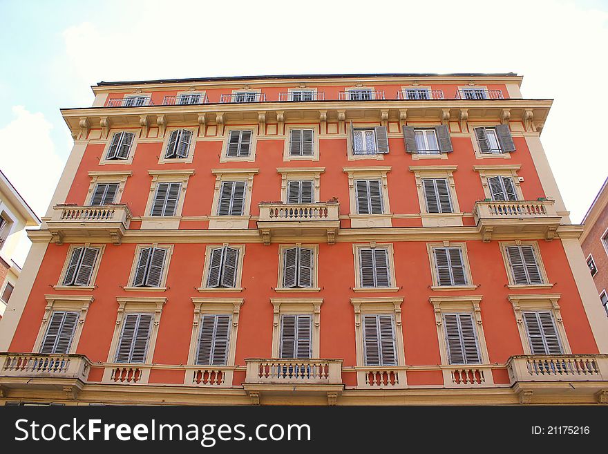 Italian town house with red brick and shutters. Italian town house with red brick and shutters.