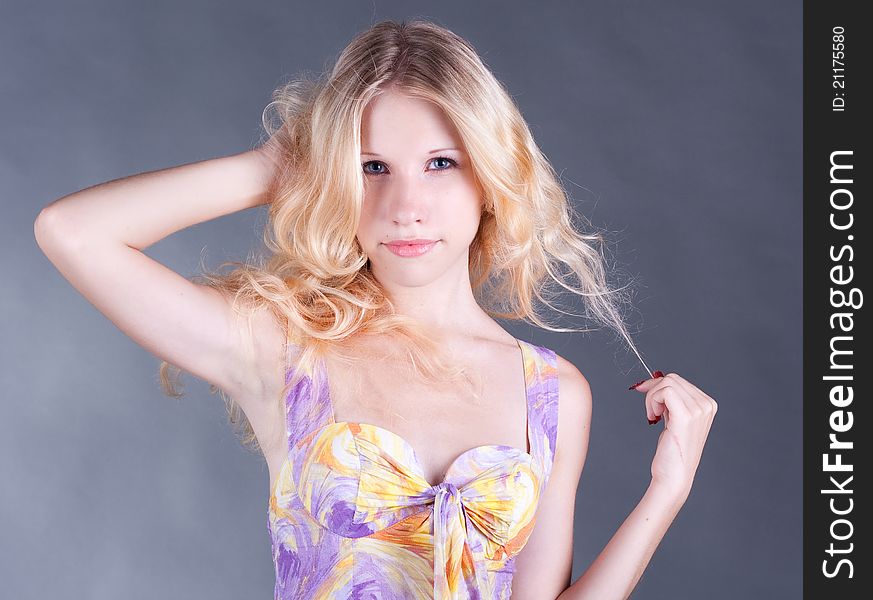 Portrait of a beautiful young blonde woman in colorful dress