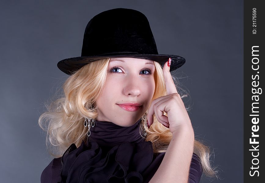 portrait of a beautiful young blonde woman in hat