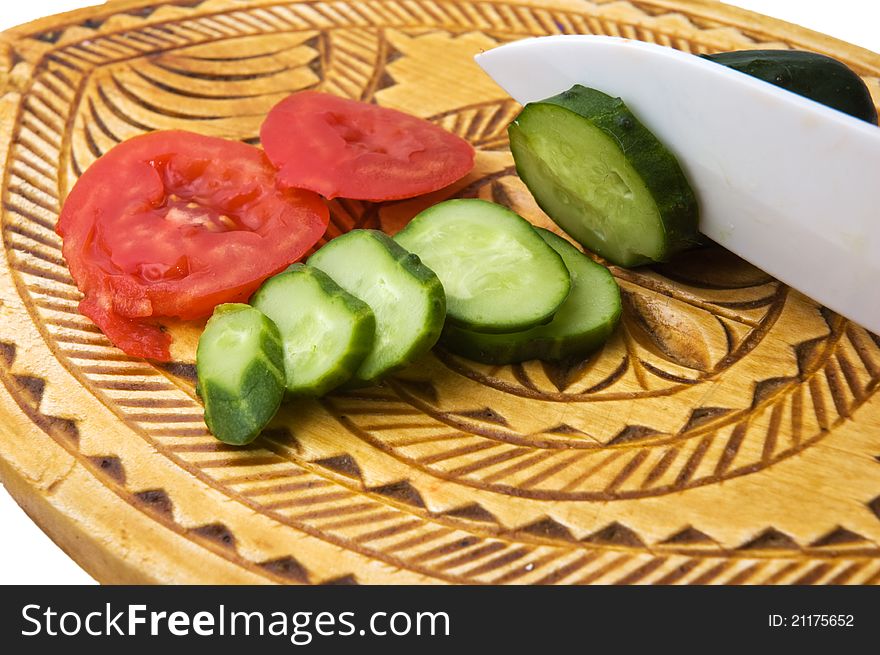 Tomatoes and cucumber on a cutting board and knife