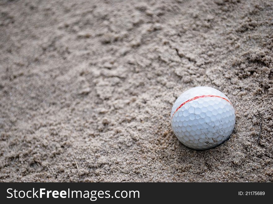 Golf ball on sand , fall to hole sand