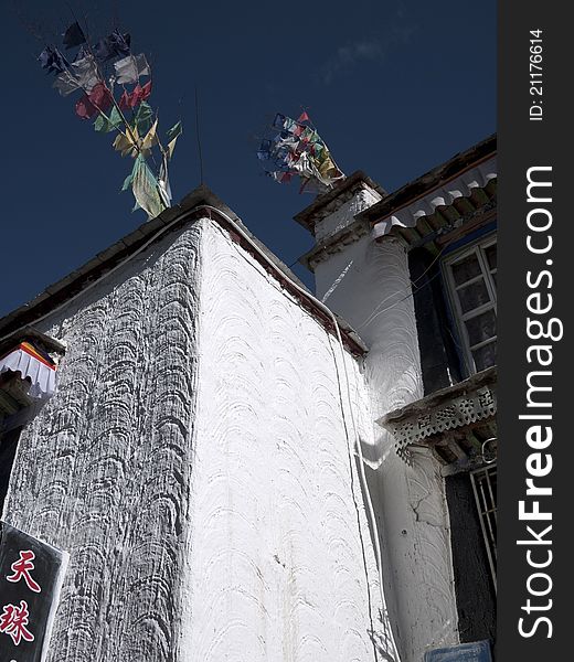 Wall of Tibetan house and five color flag