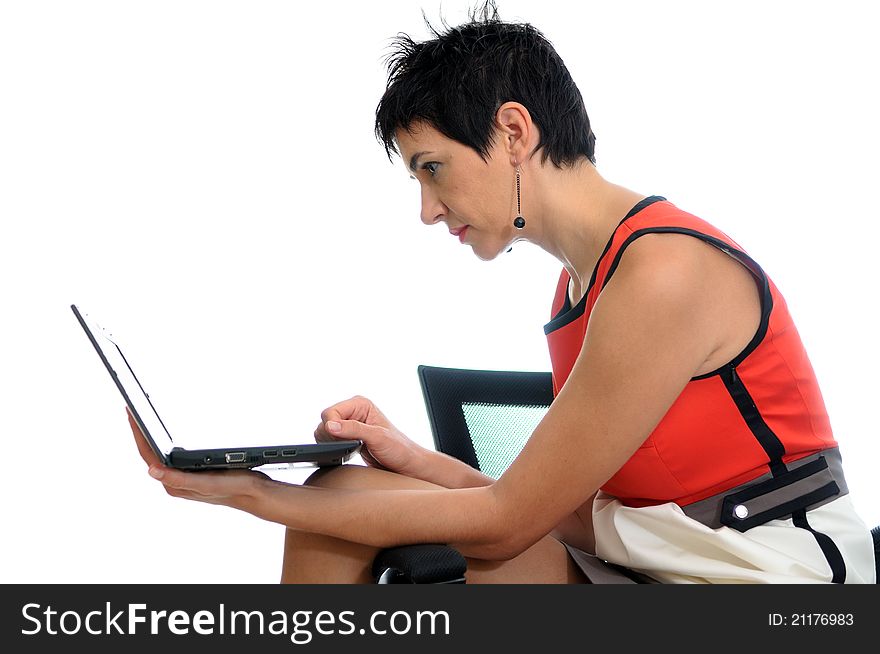 Short hair business woman on a laptop sitting in an office chair. Short hair business woman on a laptop sitting in an office chair