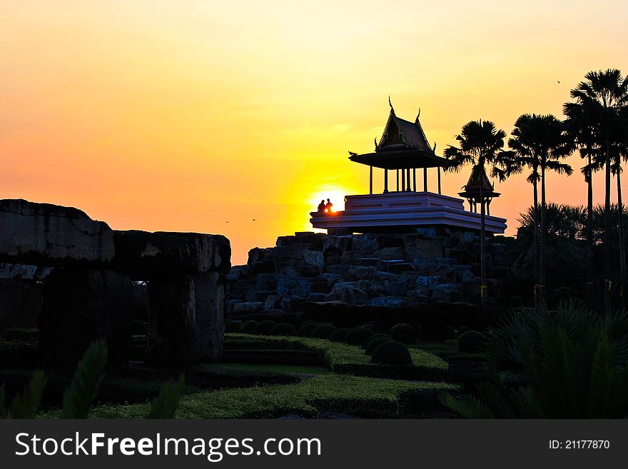 A familly take a rest on the pavilios by sunset at the stone henge in Nong Nooch Tropical Garden Thailand