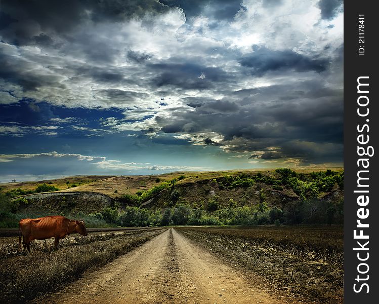 Landscape with dirt road in the mountains under cloudy sky. Landscape with dirt road in the mountains under cloudy sky
