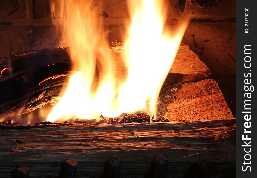 Close up of burning wood in a fire place.