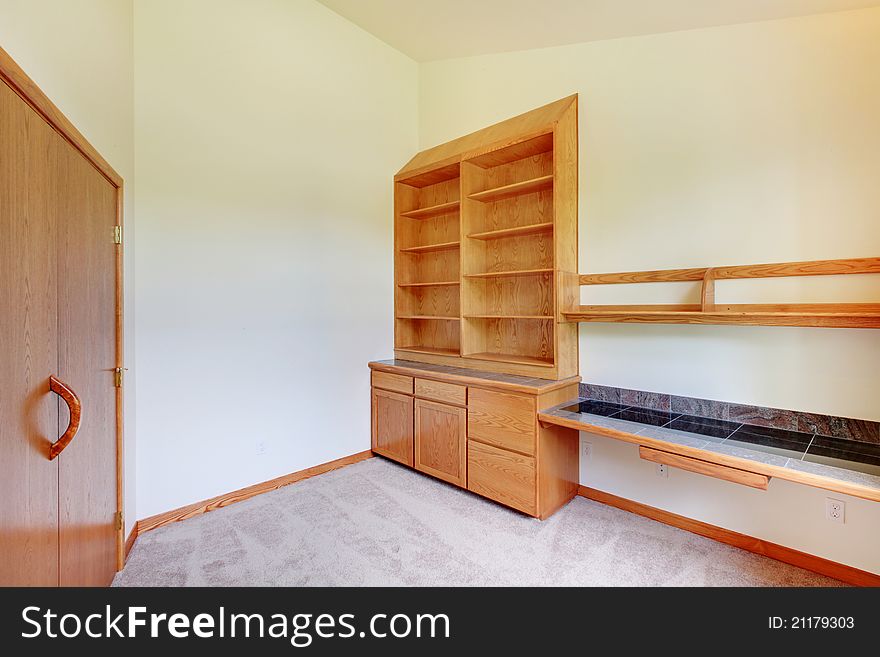 Empty room with build in book case and large door. Empty room with build in book case and large door