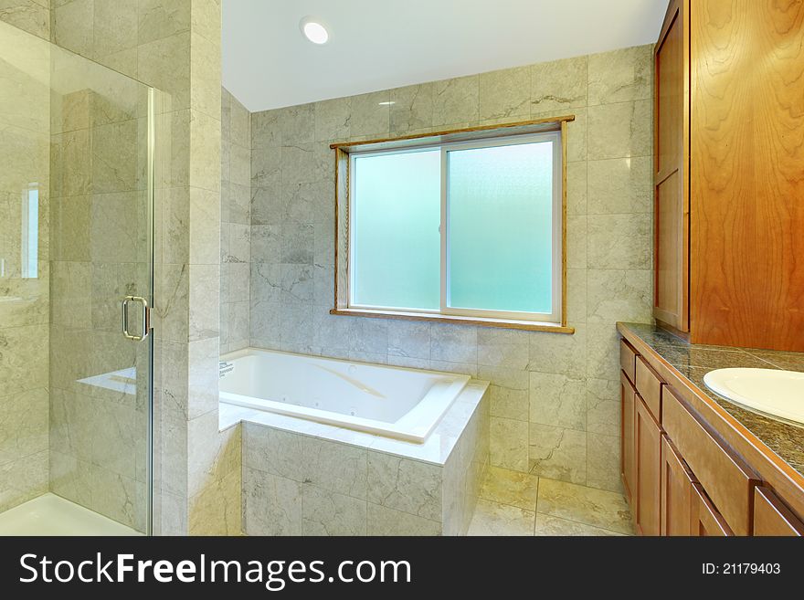 White tub with large window and tiles.