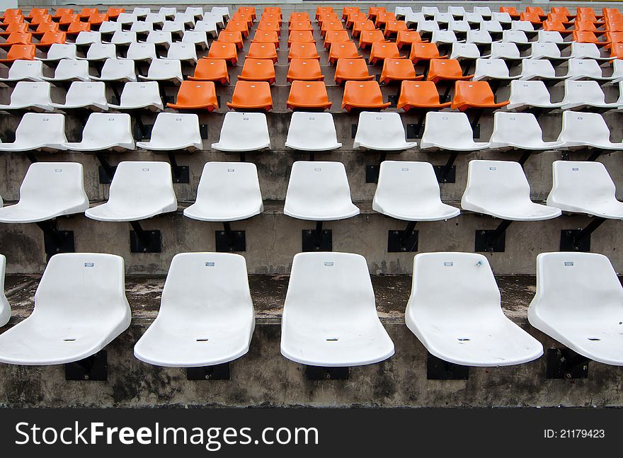 Front of the orange seats on the stadium.