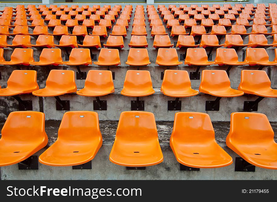 Front of the orange seats on the stadium.