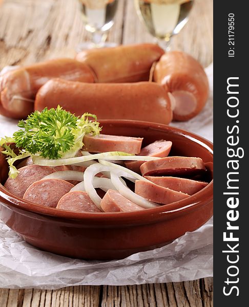 Sliced sausages with rings of fresh onion. Sliced sausages with rings of fresh onion