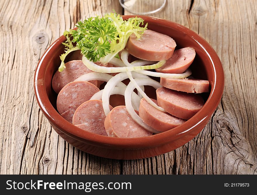 Sliced sausages with rings of fresh onion. Sliced sausages with rings of fresh onion