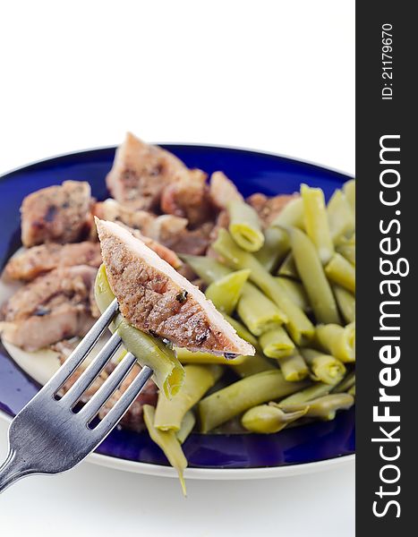 Studio shot of meal steak with green beans on white background