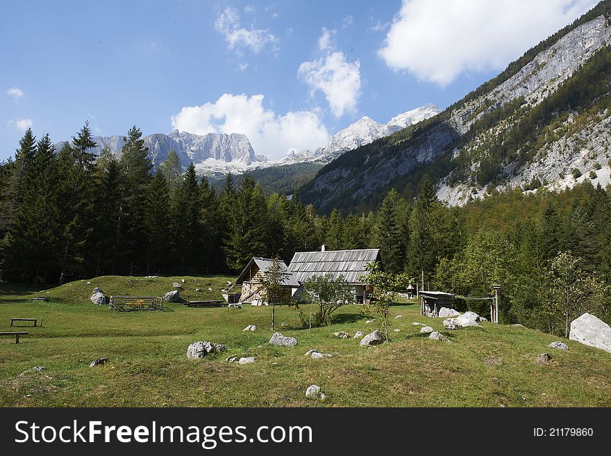 Alpine House, a high mountains meadow and blue sky. Alpine House, a high mountains meadow and blue sky