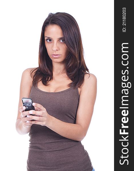 Young and beautiful woman holding a cellphone and looking serious