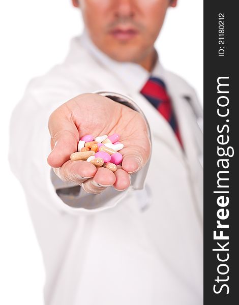 Young doctor holding a lot of colorful pills