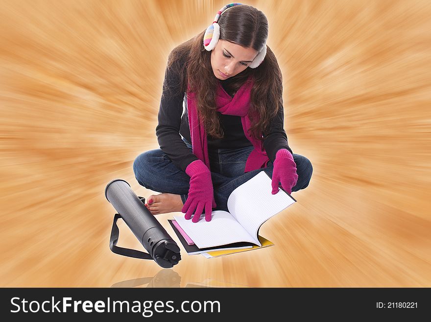 Beautiful young female student sitting on floor studying