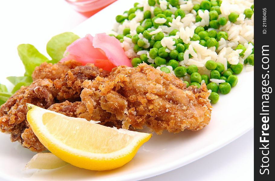 Chicken with rise served on white plate