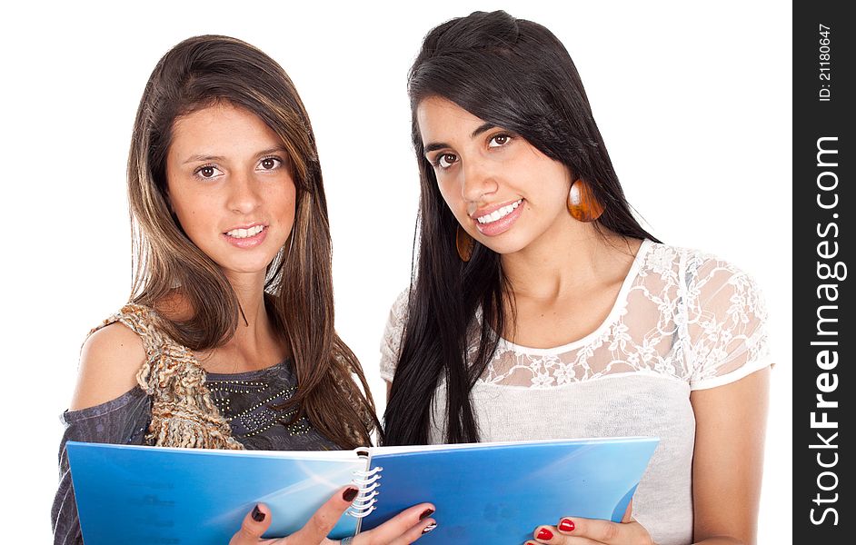 Two active happy teenage girls with notebooks on a white background