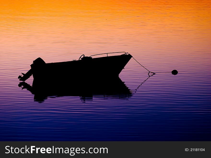 Beautiful colored sunset with lonely anchored boat. Beautiful colored sunset with lonely anchored boat