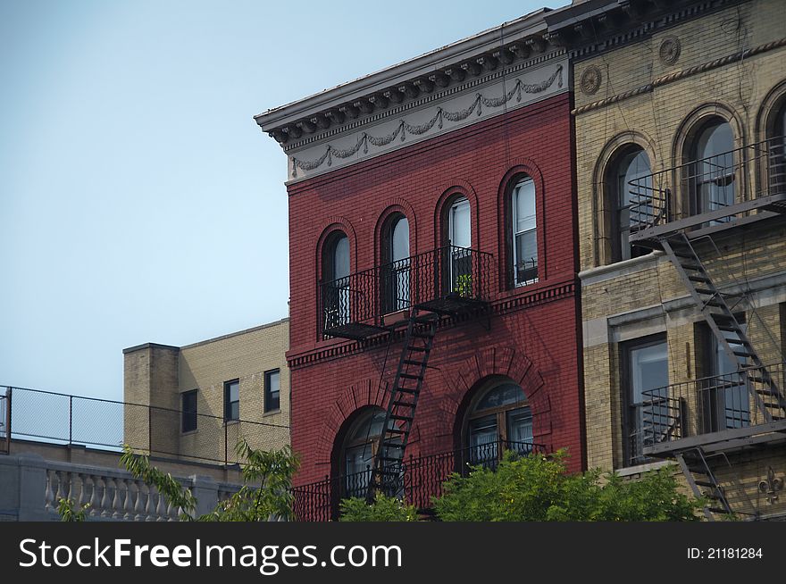 Brick buildings in different colors line the street. Brick buildings in different colors line the street