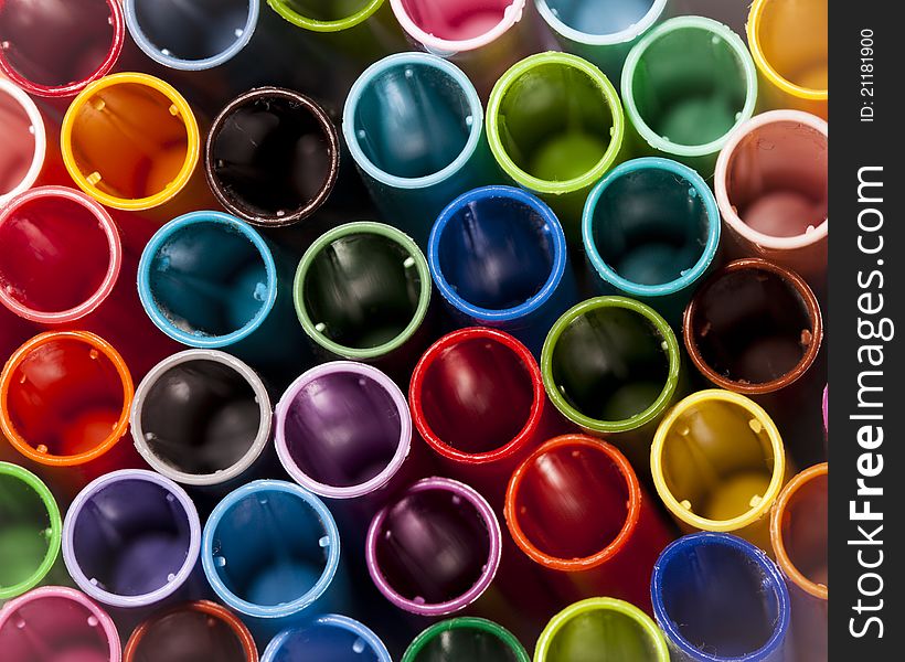 A closeup of pen caps with different colors. A closeup of pen caps with different colors