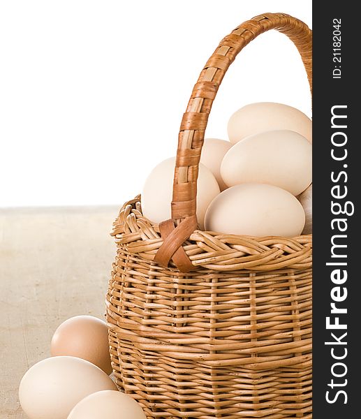 Eggs and basket on white background