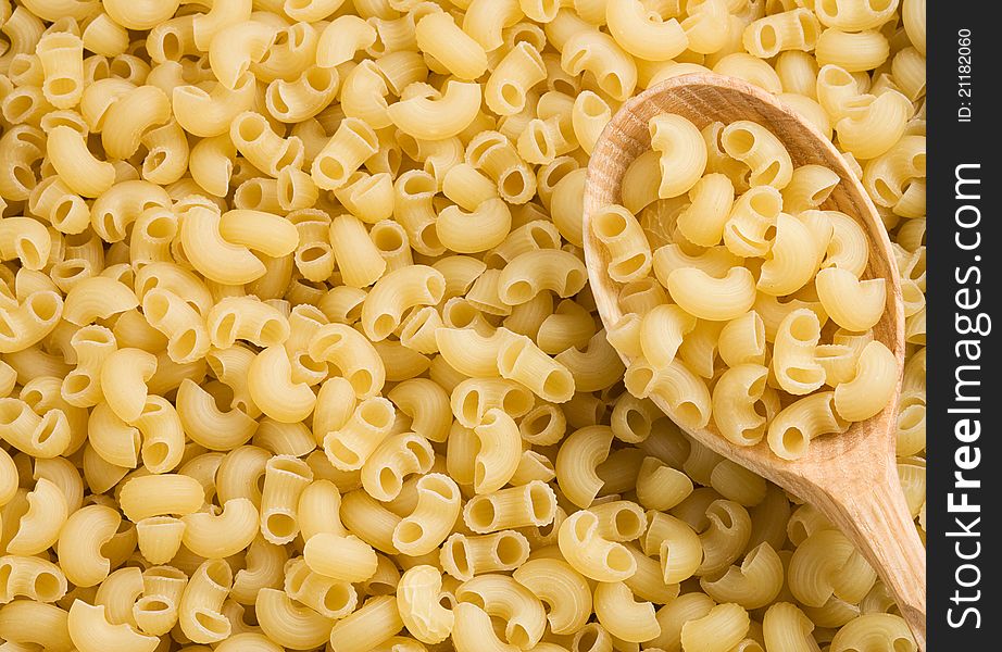 Pasta and wooden spoon as background