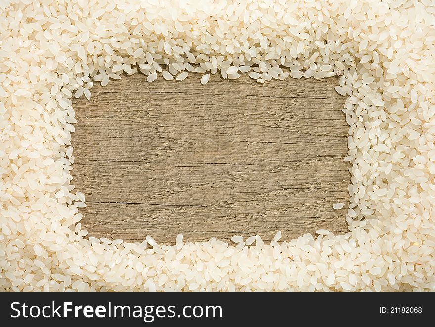 Rice grain on wood background texture