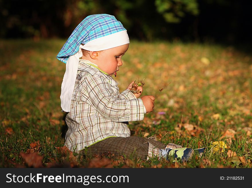 Baby Boys Sitting  In Autumn Park.